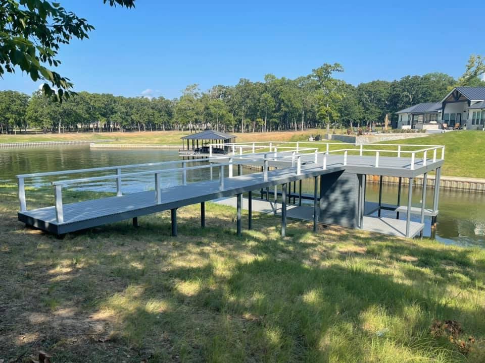 Long dock starting from land going to the water in gray color