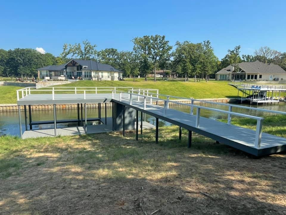 Gray colored long dock starting from land going to the water